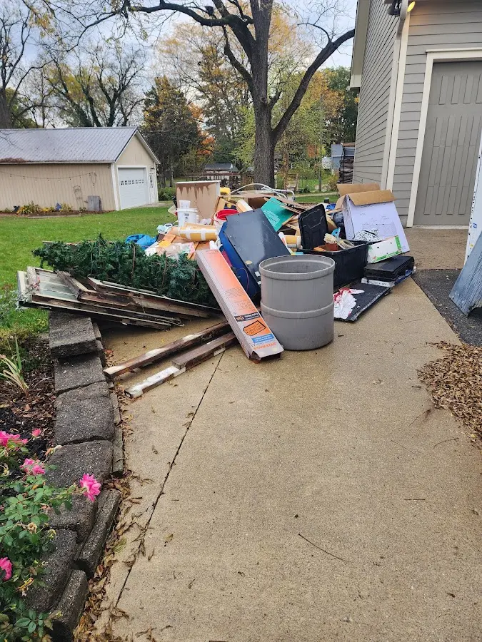 Dumpster being loaded with debris for 10 Yard Dumpster Rental in Windsor